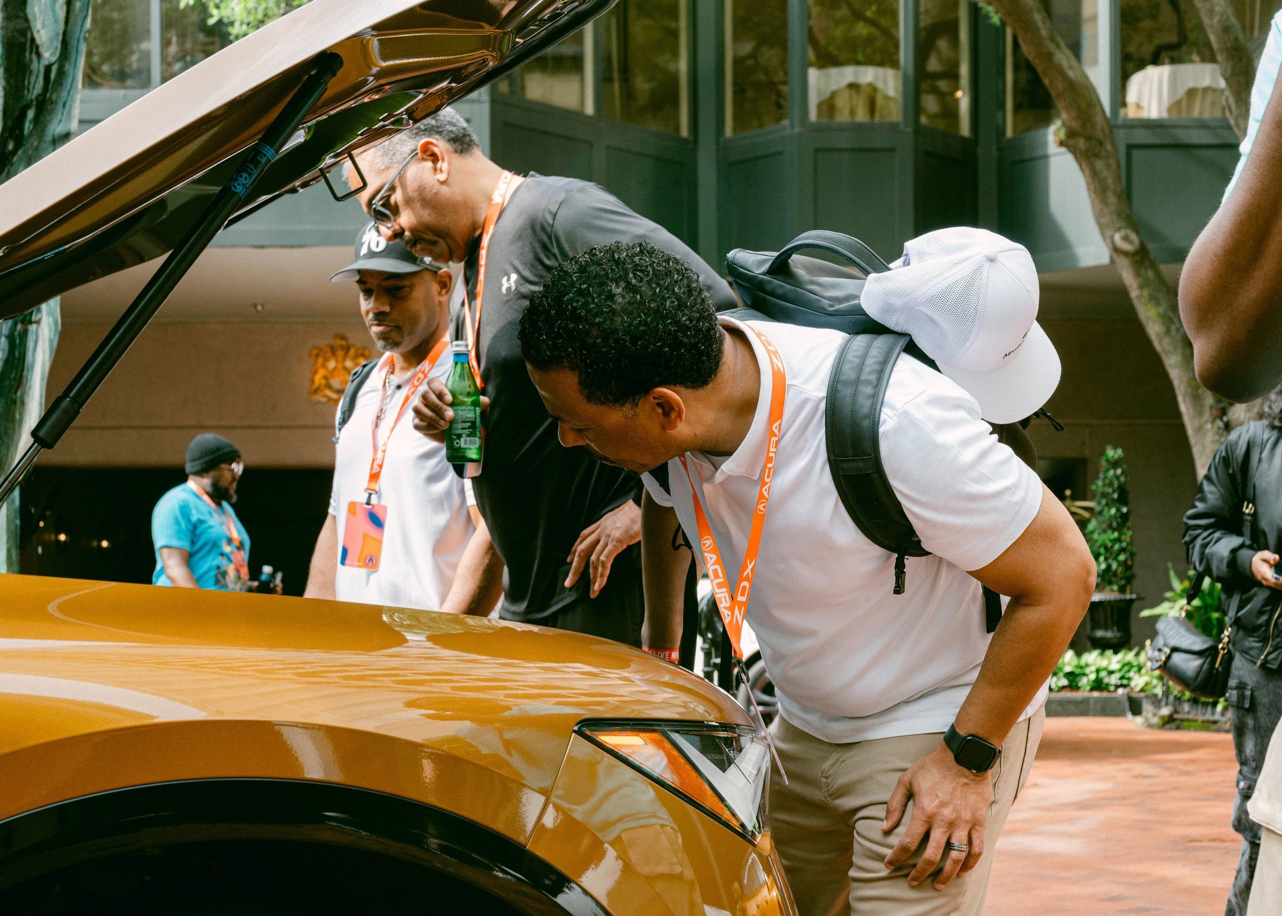 Group examining vehicle at car show
