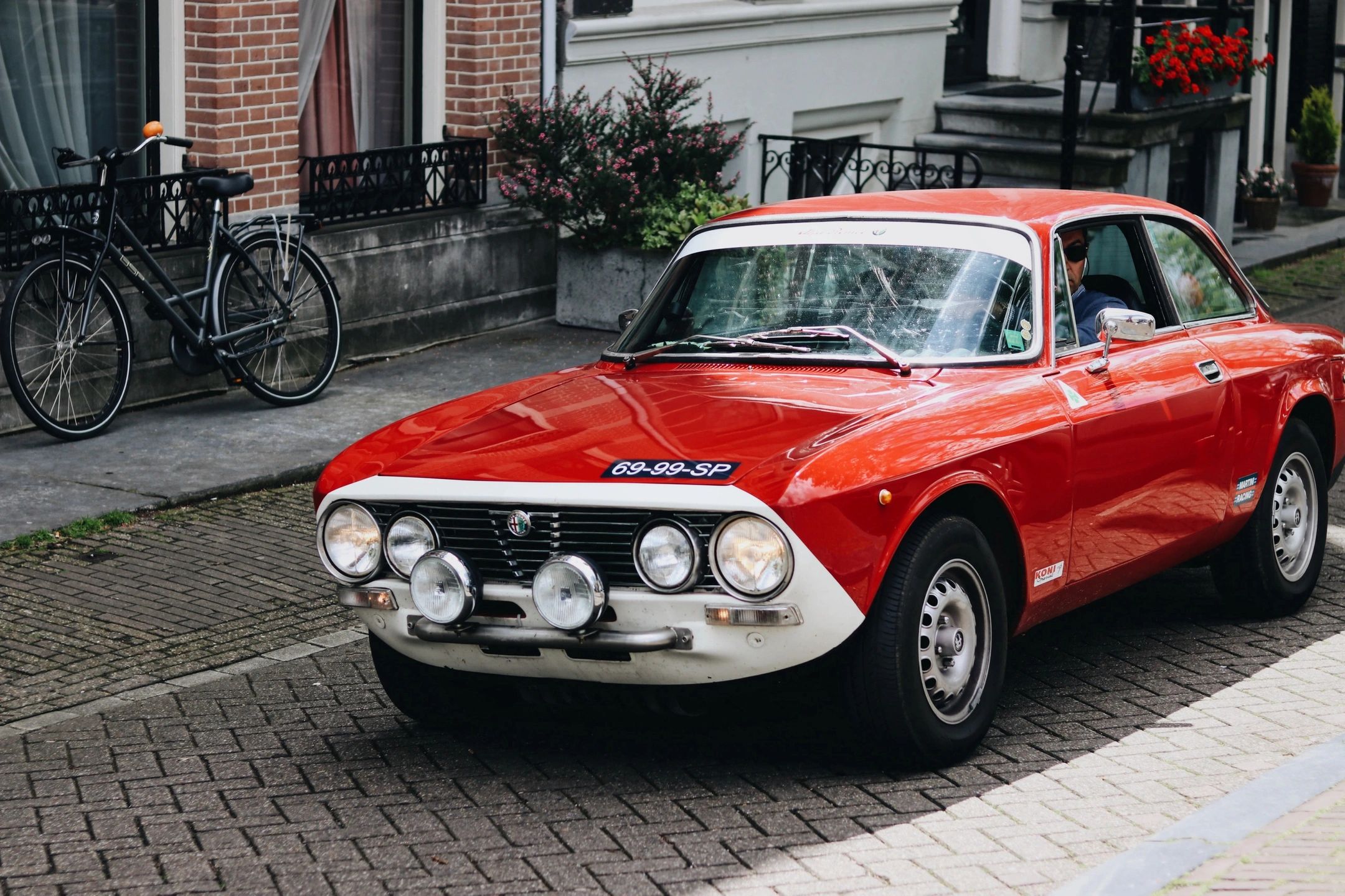 Vintage red sports car on brick street